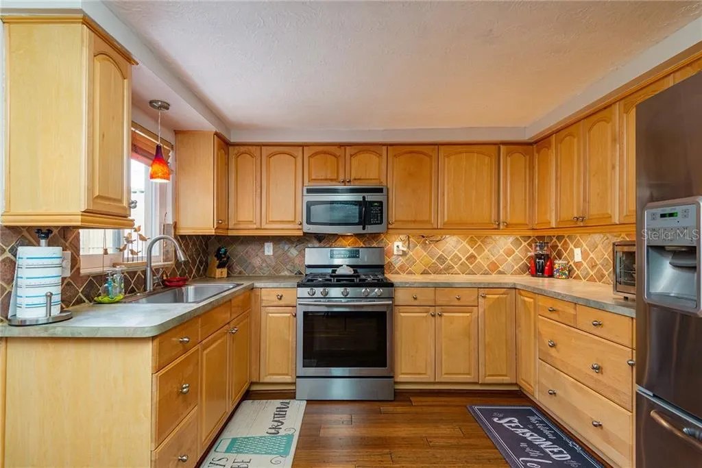 Kitchen sink, gas range, and generous cabinet space
