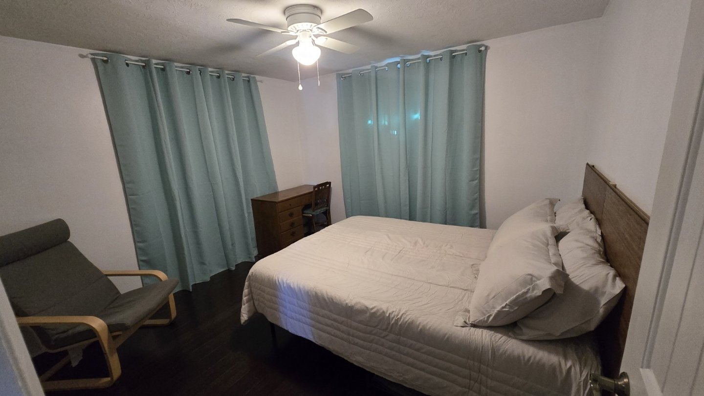 Second bedroom · Bed & seating at Suncoast Tropical Garden Retreat