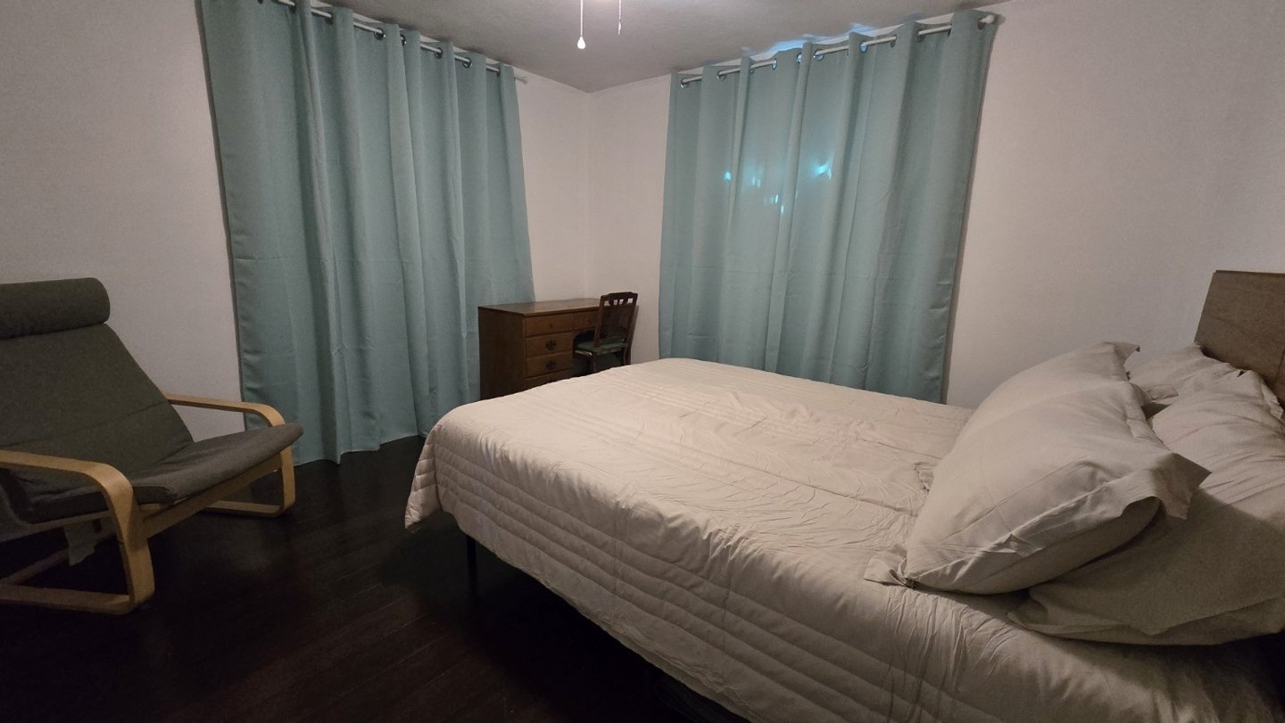 Second bedroom · Reading chair at Suncoast Tropical Garden Retreat